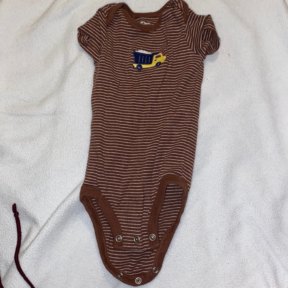 Brown short sleeved buttoned onesie.